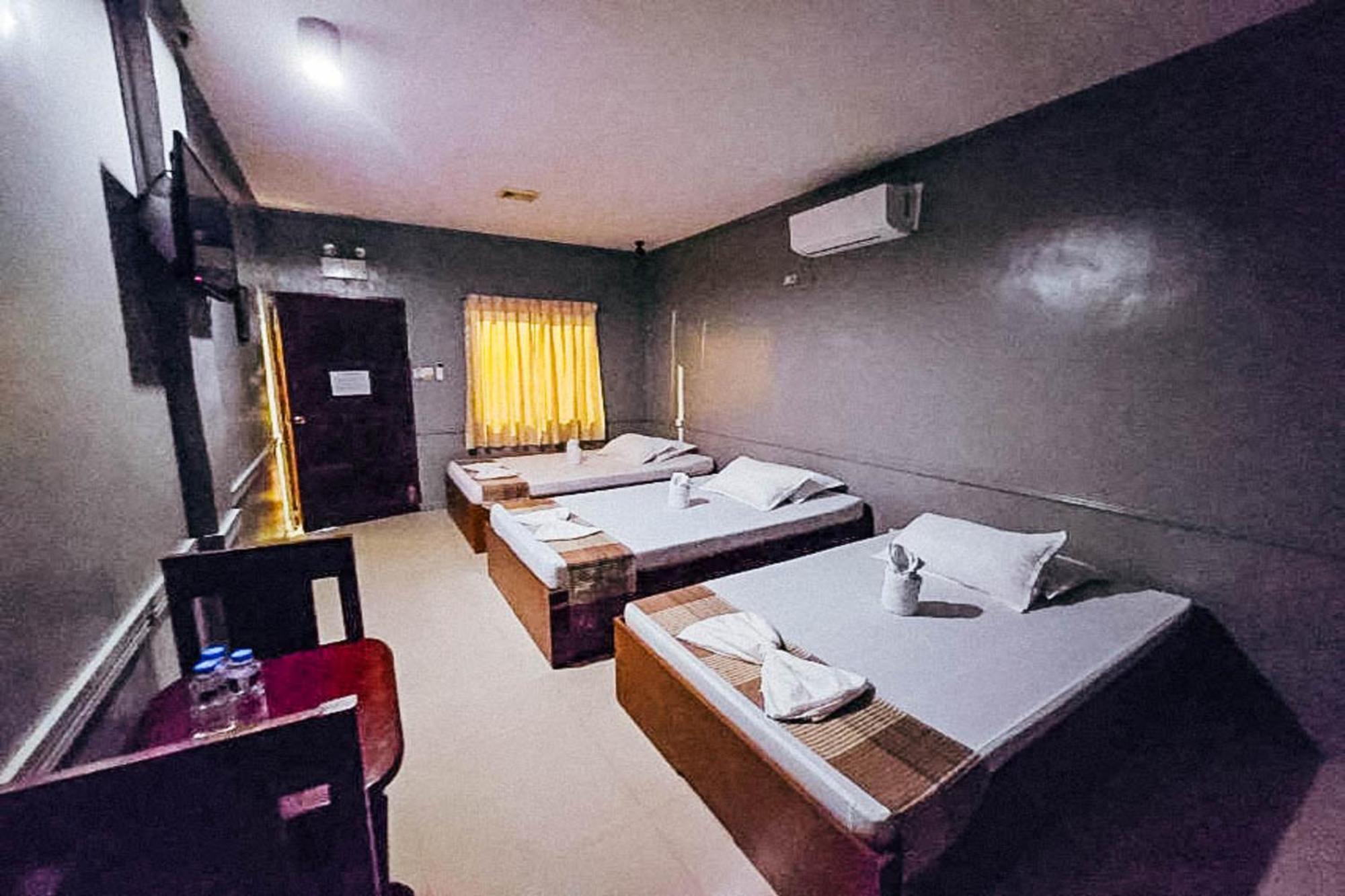 Mbg Travellers Inn Powered By Cocotel Puerto Princesa Quarto foto
