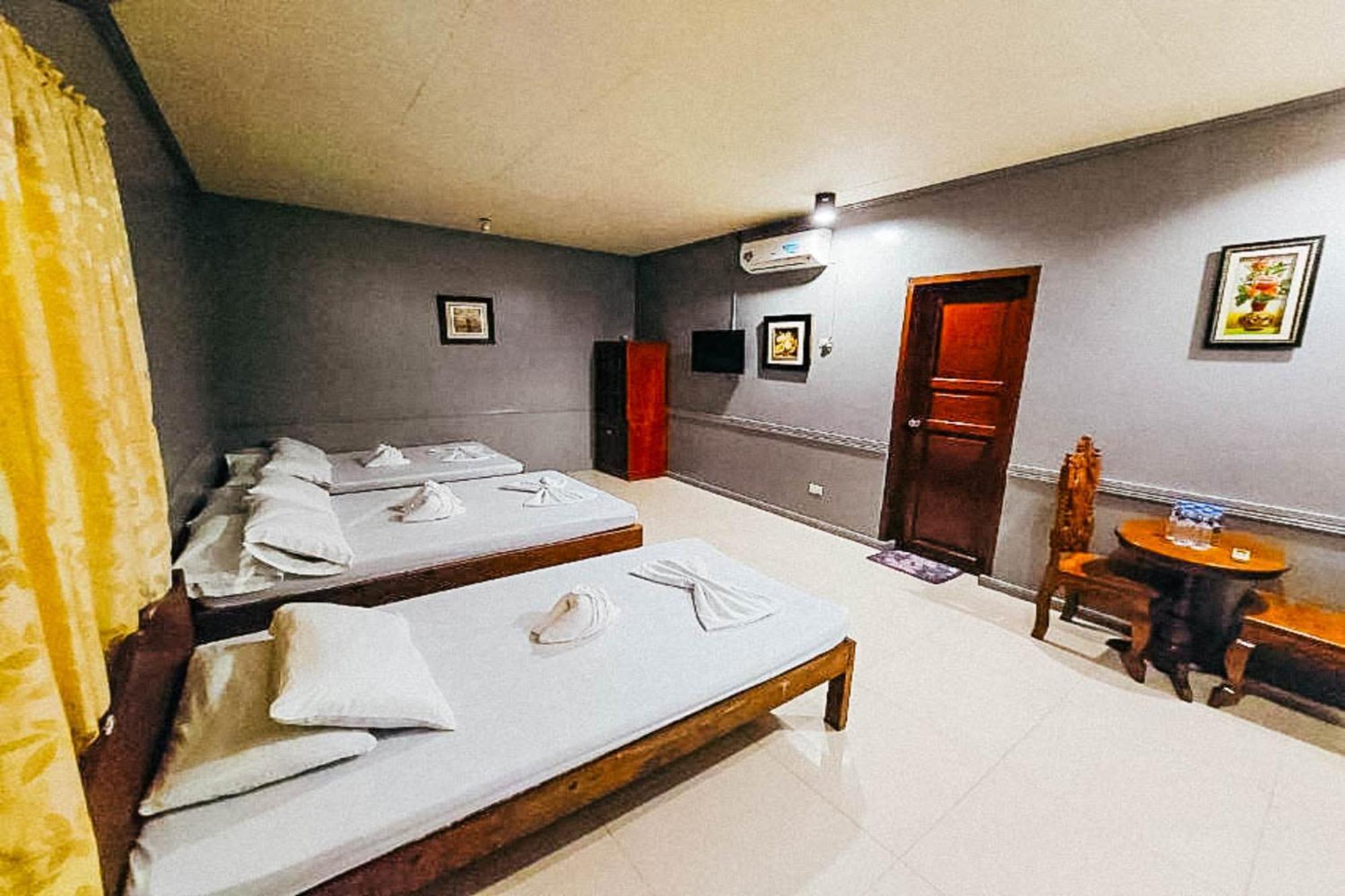 Mbg Travellers Inn Powered By Cocotel Puerto Princesa Quarto foto