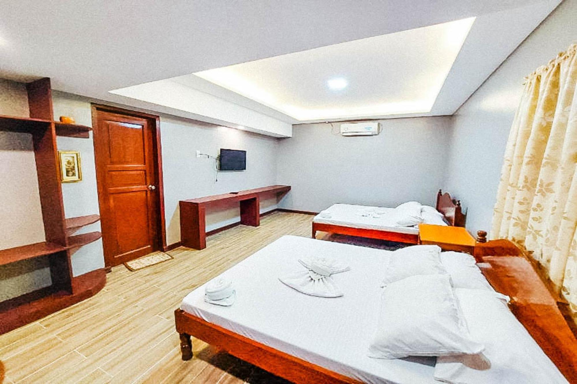 Mbg Travellers Inn Powered By Cocotel Puerto Princesa Quarto foto